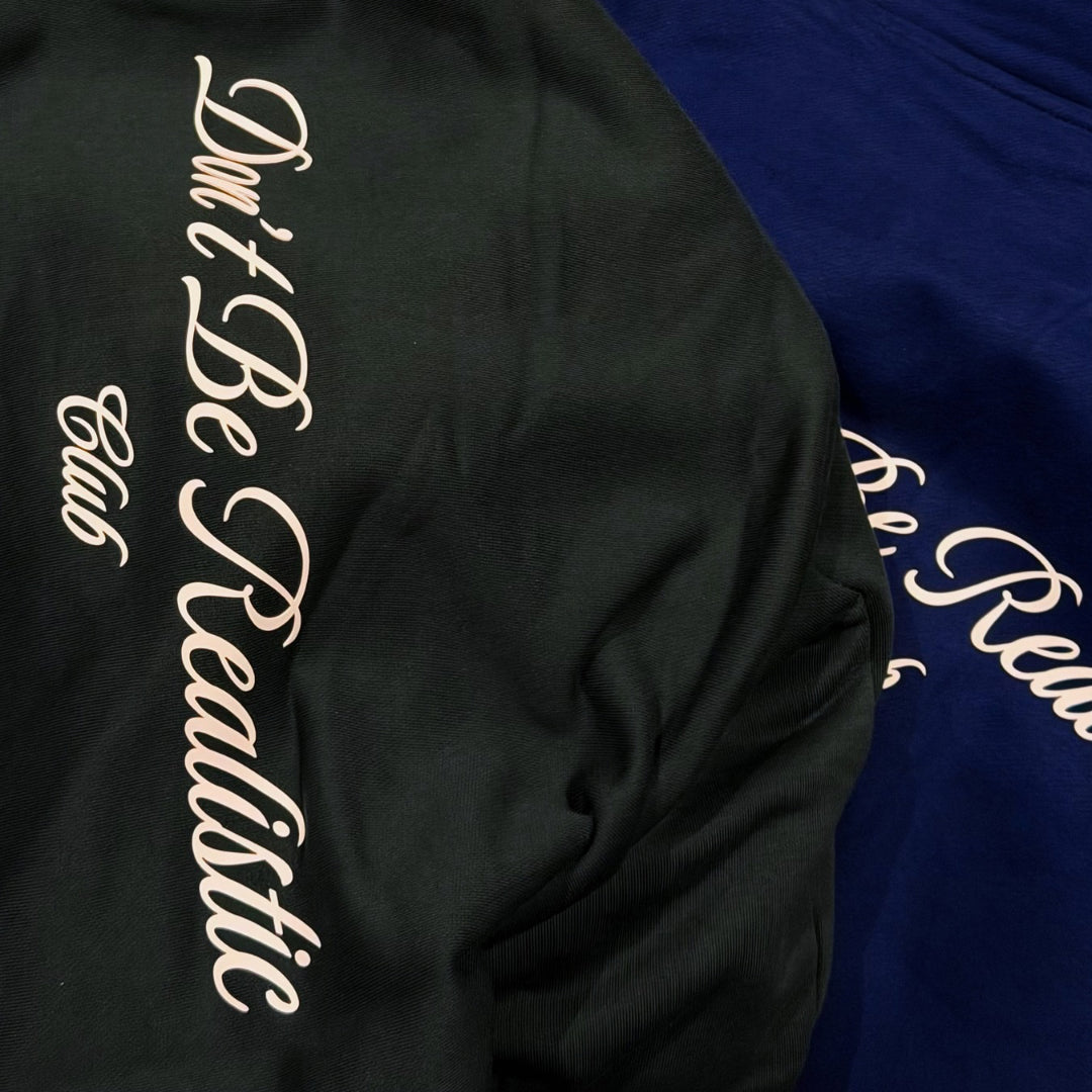 don’t be realistic club hoodie
